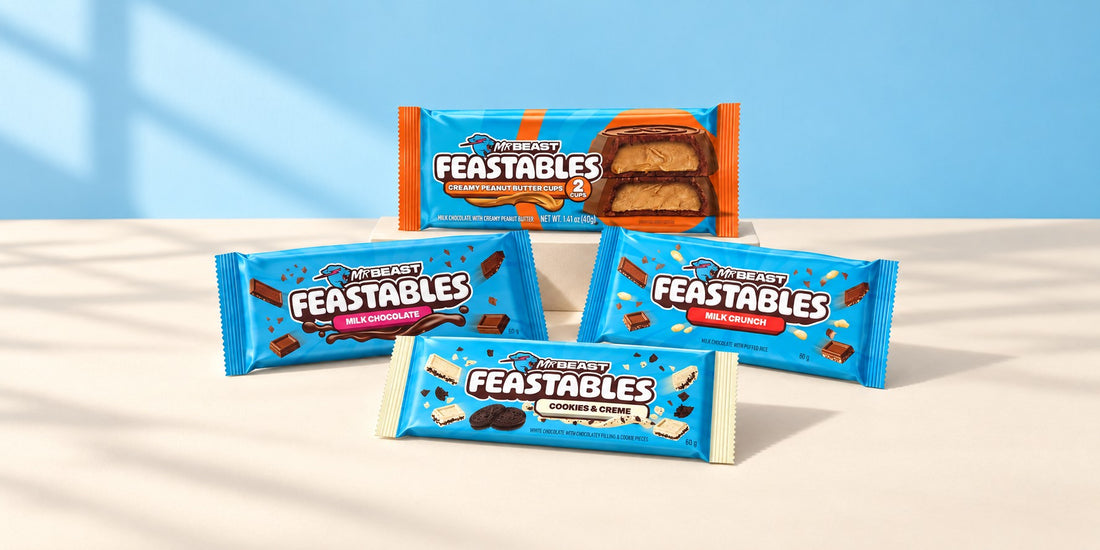Feastables Milk Chocolate, Milk Crunch, Cookies & Cream bars and peanut butter cups on cream paper